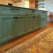 Teal glazed island cabinetry